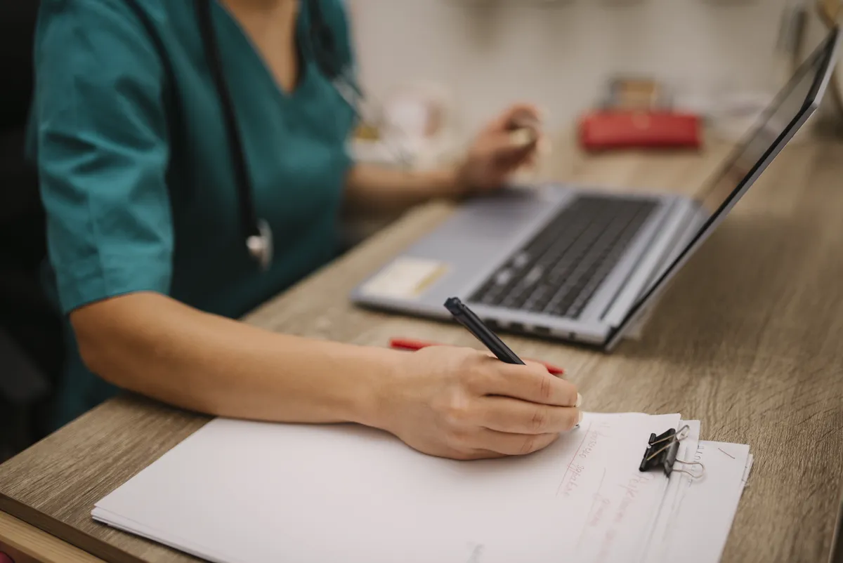 Clinician working on a laptop in a medical office